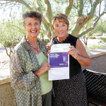 Mary Beth Fisher presents to Terry Price, chairperson for the fourth annual Walk to End Alzheimer’s, a check for $173.
