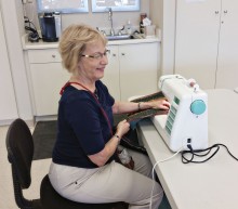 New member Jodie Spiller works on binding a charity quilt.