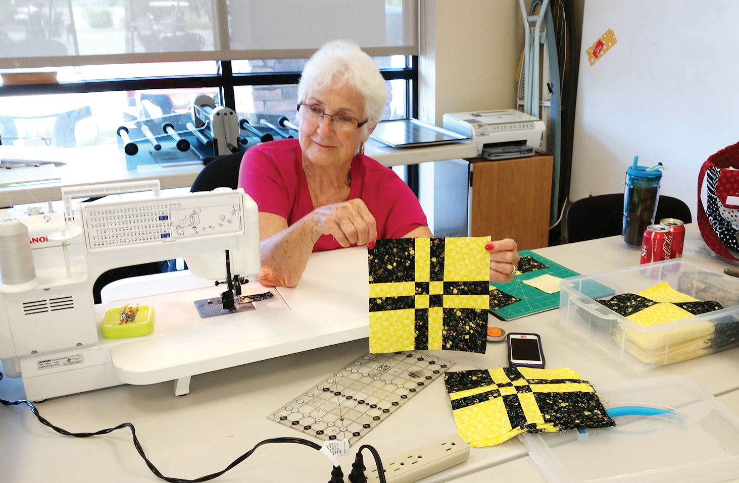 Dottie Welsh constructing the Disappearing 4-Patch Block; photo by Sue Price.