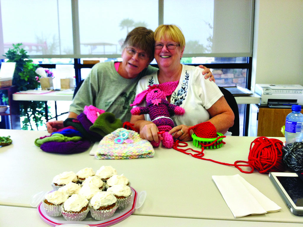 Izzy Ocheltree and Judy Ault are working on chemo hats and toys for children.