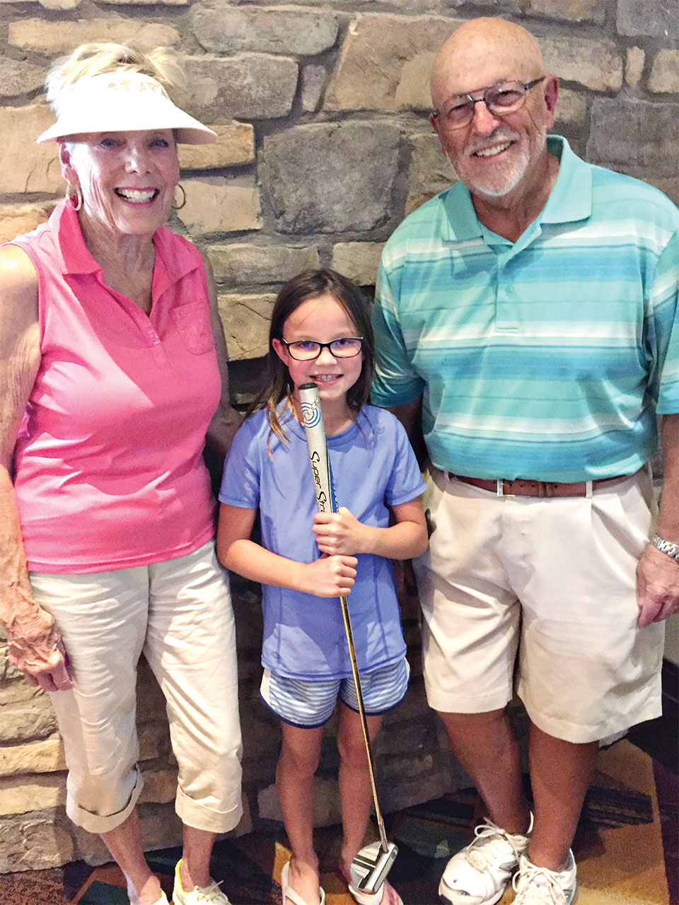 Sandy, granddaughter Chloe, and Dick Christopher participate in the putting league on June 8.