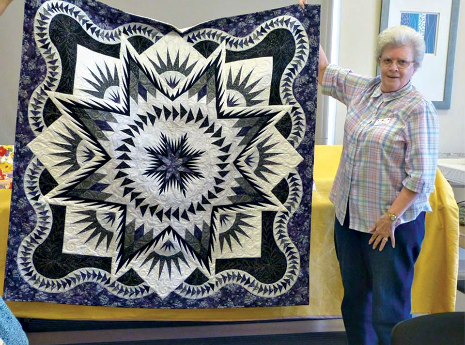 Judy and her purple and white sparkle quilt