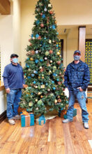 Maintenance team members Kacey and Alex set up and decorated the Christmas tree with the help of Marco (not shown).