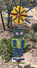 Totem with yellow and blue starburst by Chris Maloney