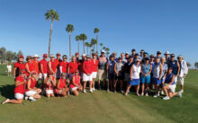 The Red and Blue Teams dressed to win! Golf pro Jay Wilson keeps the two rival teams separated.