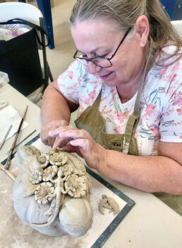 Kathy Laubon finishing touches—do you see a lizard?
