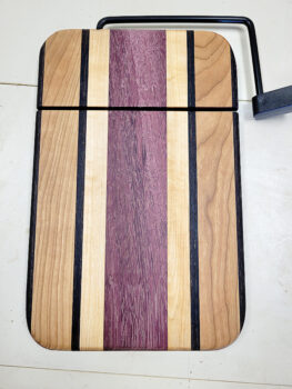 A variety of woods make up this gorgeous cheese cutting board.