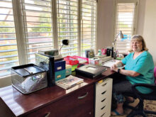 Chris at her craft desk in her Arizona home