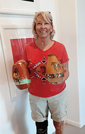 Marti holding gourds