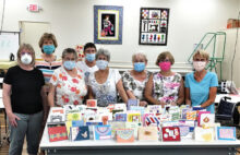 Some Paper Crafting Club members display their work.