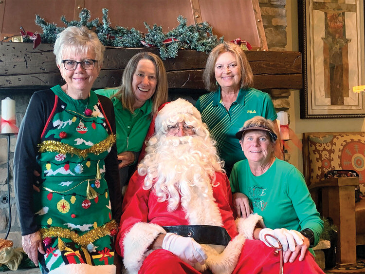 Posing for a “green” picture with Santa are Shirley Eliuk, Cindy Jensen, Mary Kindt, and Julie Carl.