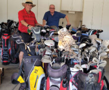 Russ Stocek (left) and Scott Van Loan of the Junior Golf Association of Arizona (right) with donated golfing equipment.