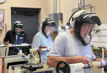At the lathe, front to back: Gary Plendl, Kathy Saltus, Chuck Holt