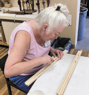 Kathy Saltus, club secretary, preparing the wood
